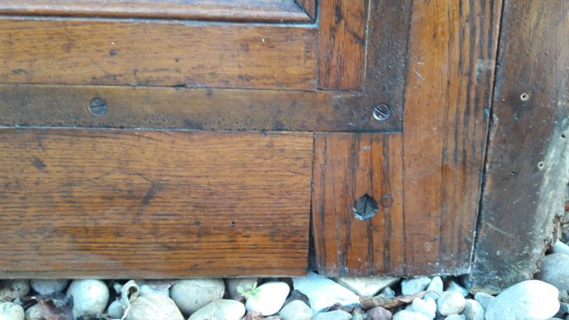 Oak entrance door and its frame and transom, wrought iron gates