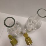 pair of decanters, bottles or jars, made in crystal with a ceramic tap enameled in green color