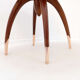 Round Art Deco side table in wood with curved legs and brass feet.