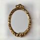 Small vintage oval wall mirror in varnished gold resin