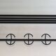 Designer coat rack in blackened metal