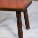 Brutalist coffee table in orange ceramic and solid wood.