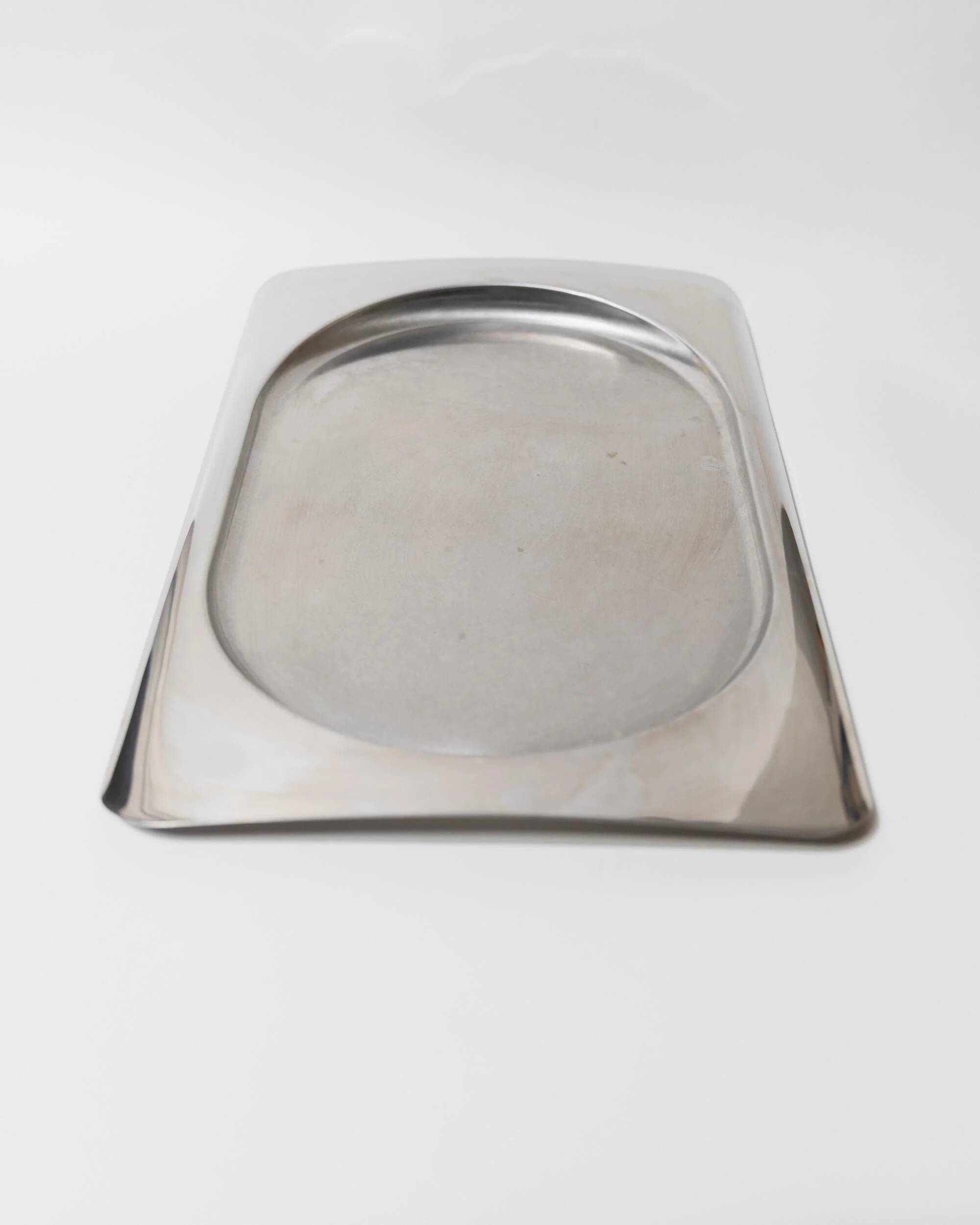 1990s vintage stainless steel platter, rectangular with an oval indentation, minimalist modern design.
