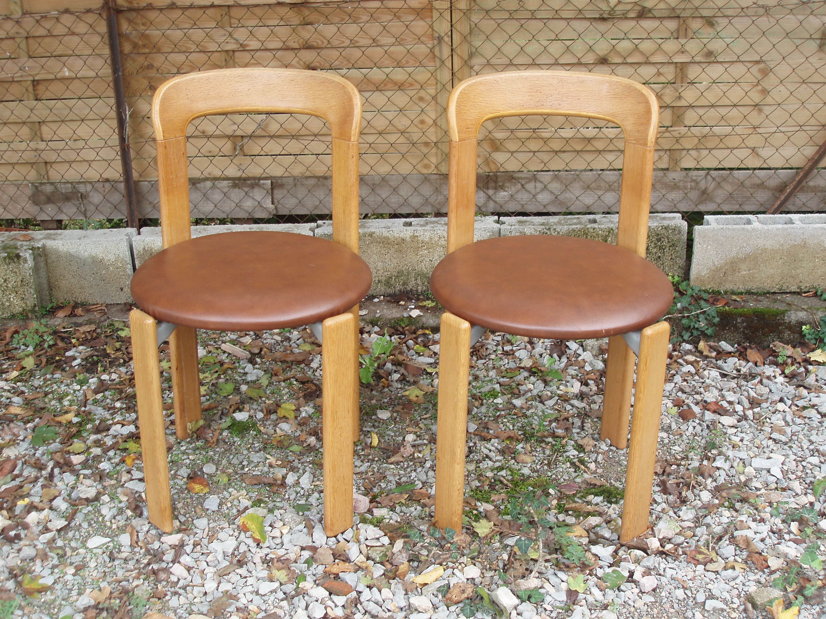 Pair of chairs by Swiss designer Bruno Rey in wood and brown skai