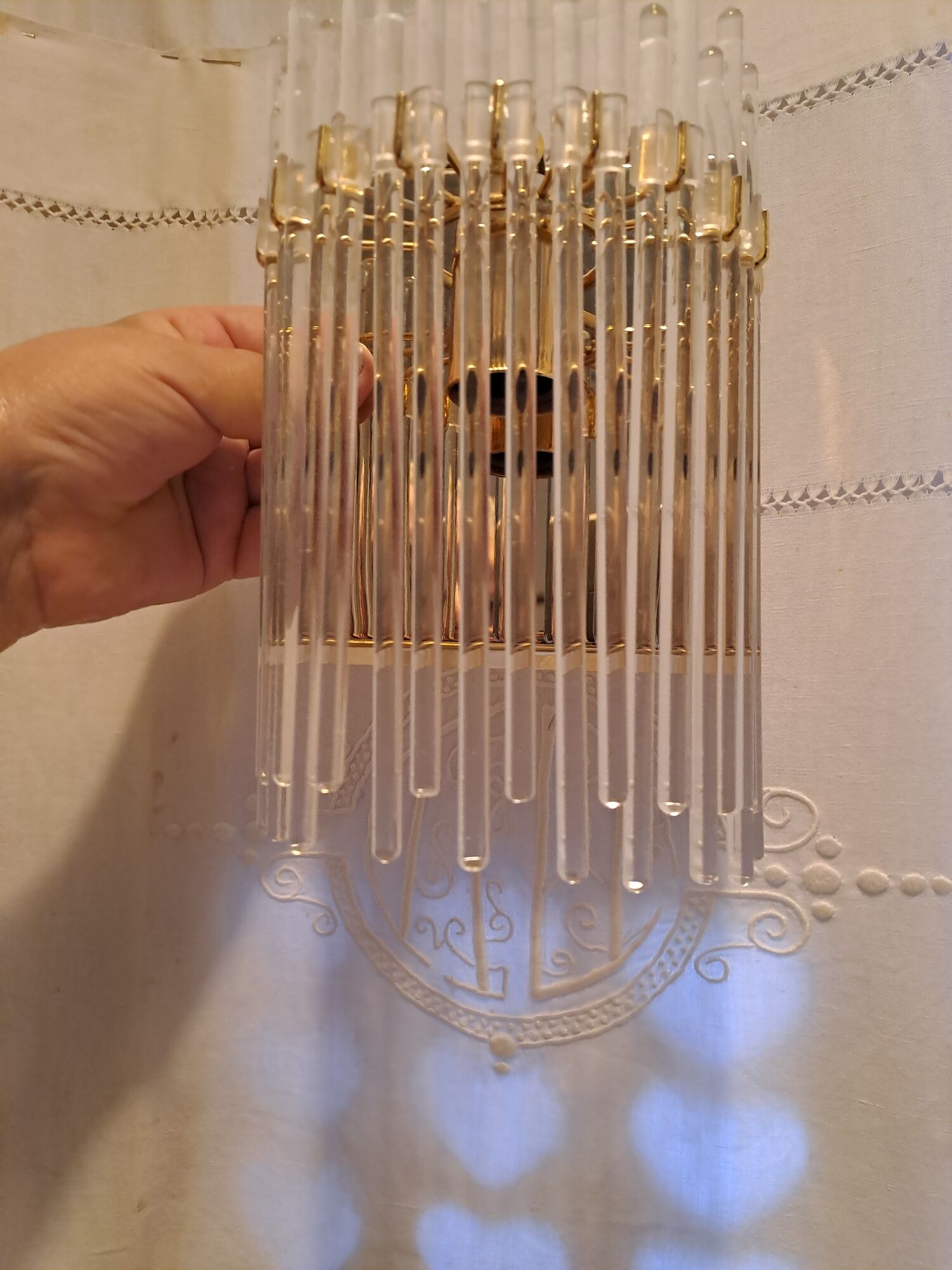 Pair of wall lights with hanging glass pendants in gold color