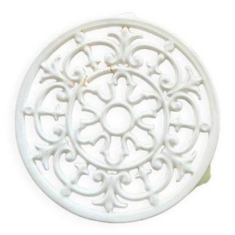 Old white cast iron trivet