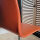 2 orange faux leather swivel chairs