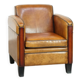 Sheepskin Art Deco design armchair with beautiful wooden details and black piping