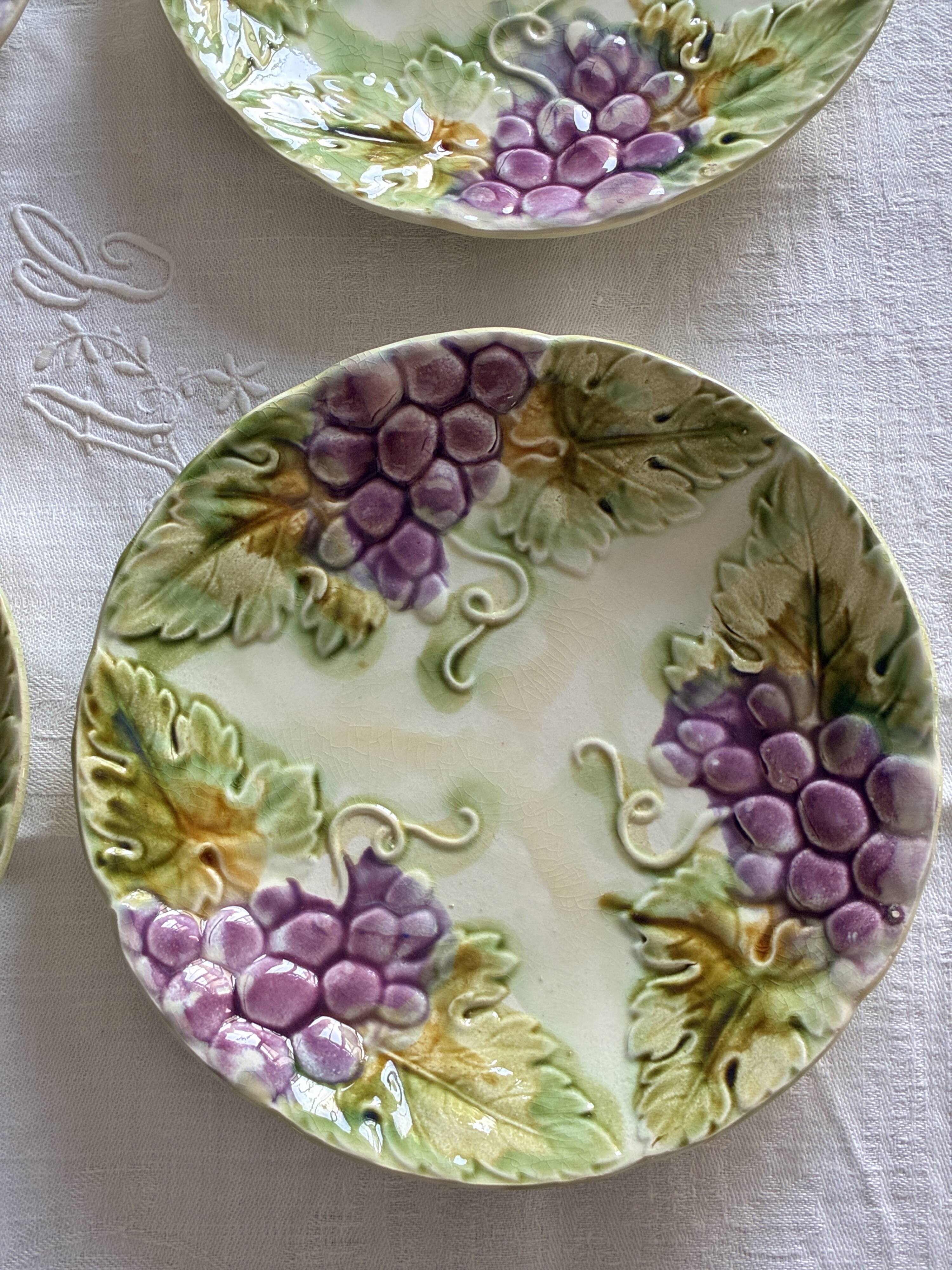 Lot of 4 Onnaing barbotine plates with grapevine design.