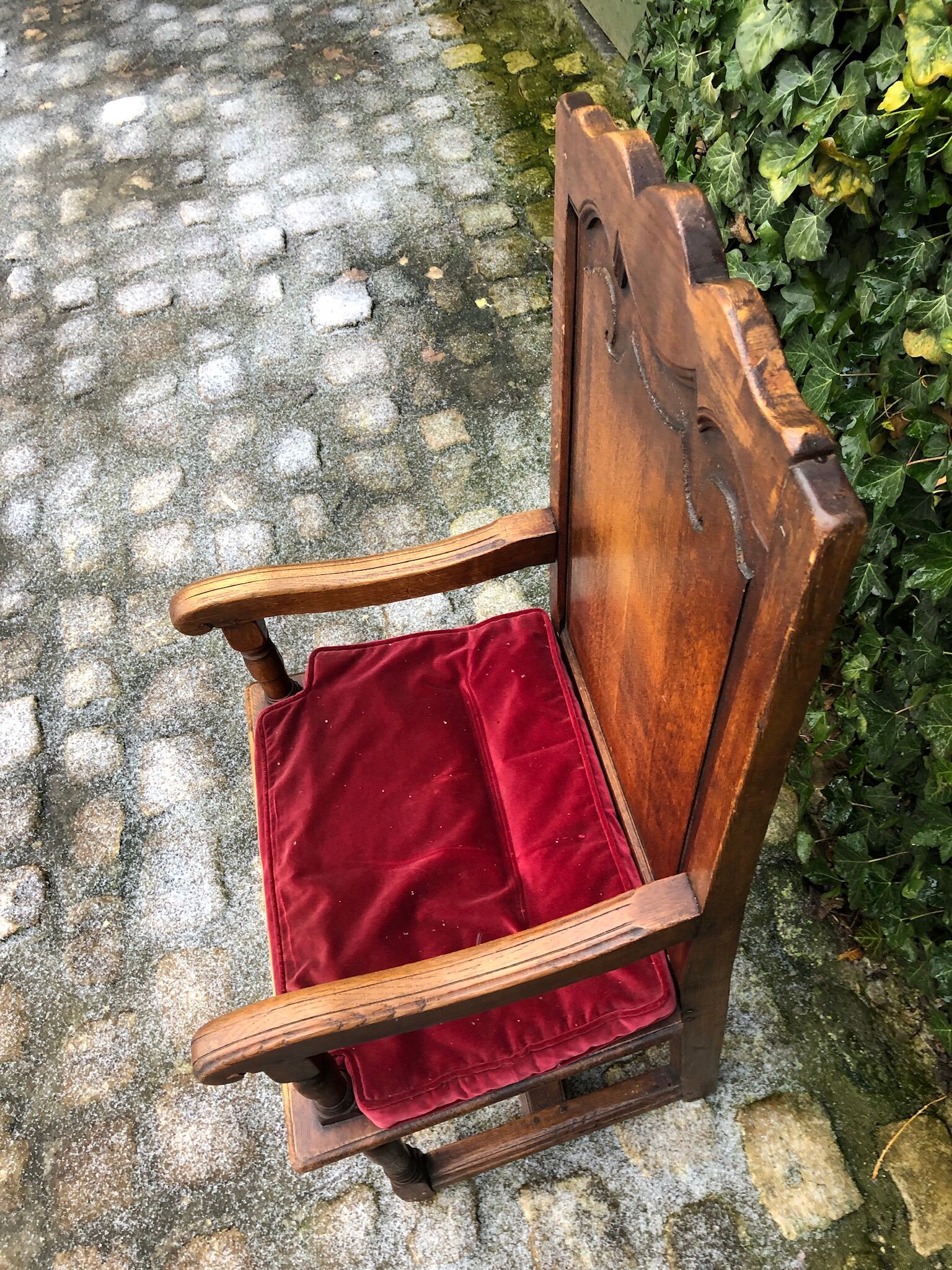 Wooden armchair with velvety red cushion