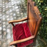 Wooden armchair with velvety red cushion