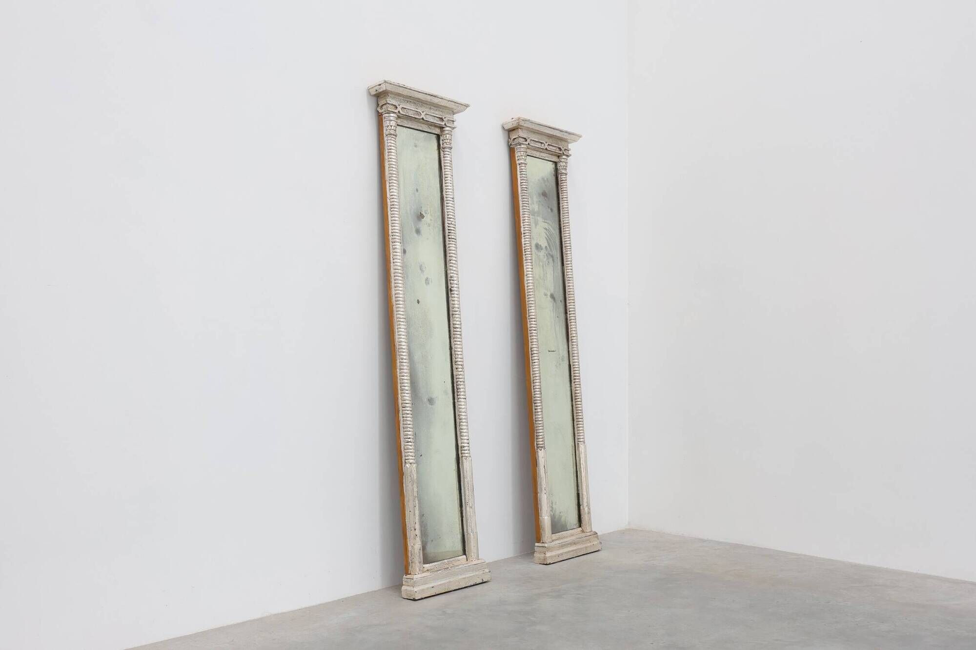 Pair of Neoclassical Silver Leaf Pier Mirrors with Ringed Columns and Corni