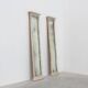 Pair of Neoclassical Silver Leaf Pier Mirrors with Ringed Columns and Corni