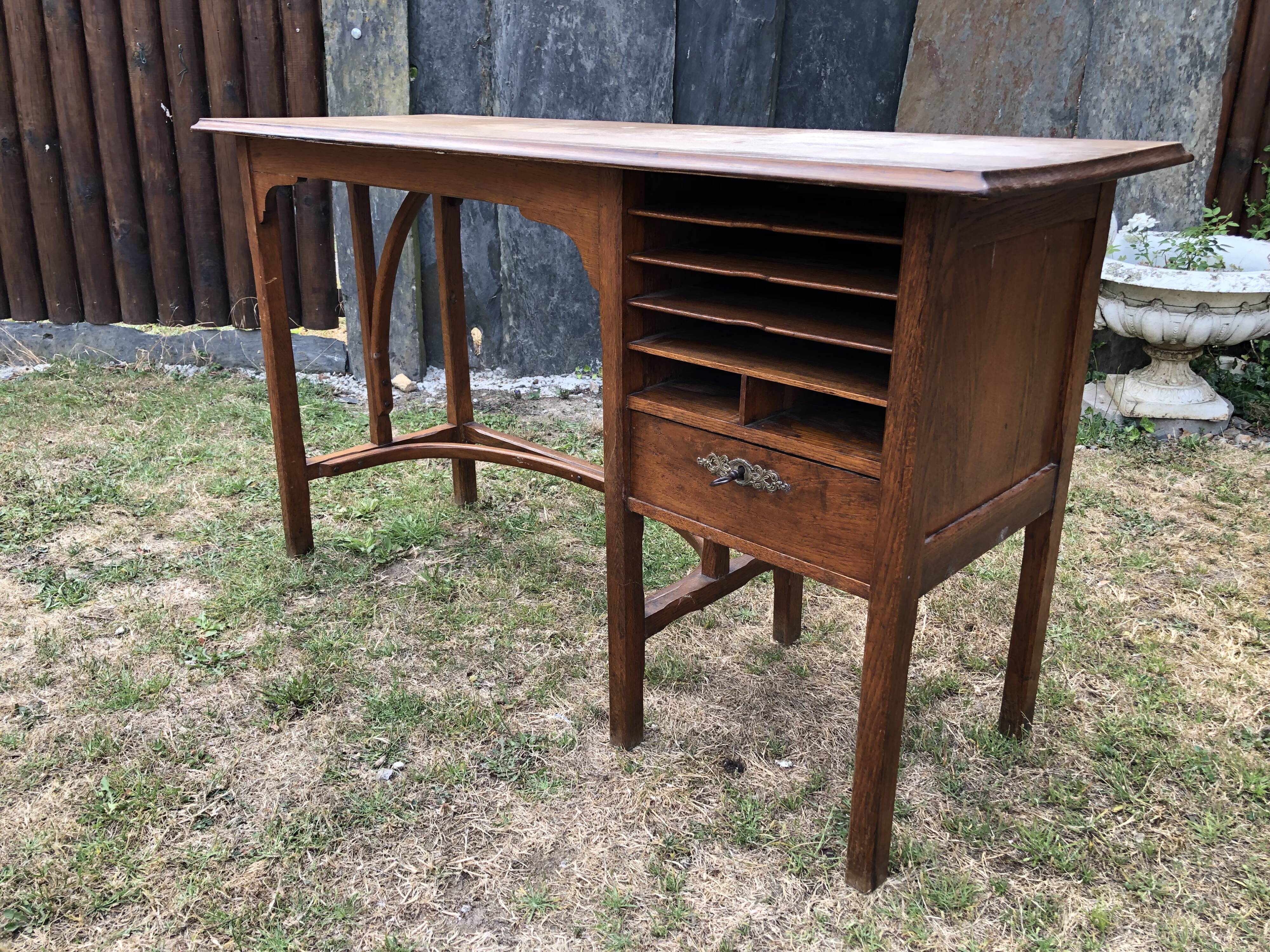 Old oak desk with curved wooden sleepers in the Art Nouveau spirit of the early 20th century.