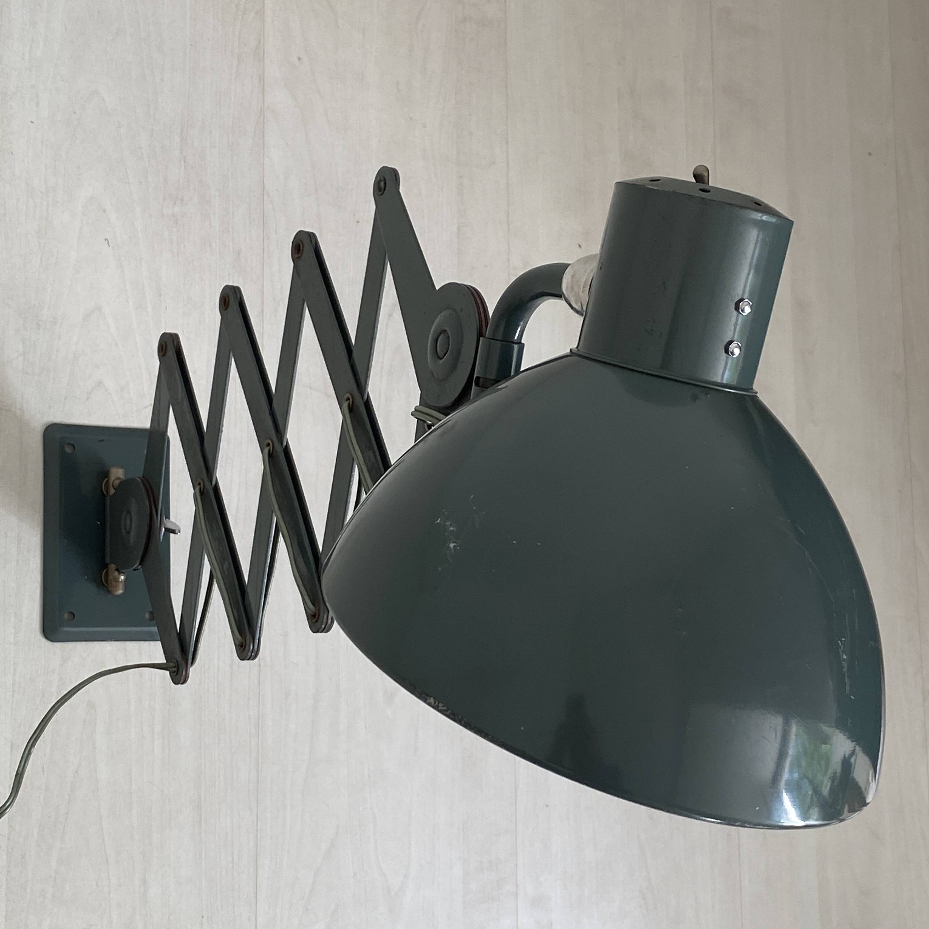 Vintage 1950s green lacquered sheet metal workshop wall light with accordion arm.