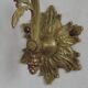 Simple wall sconce in French Art Nouveau bronze with a white glass shade featuring patterns.