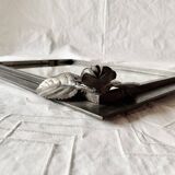 Vintage wall mirror in varnished steel decorated with a rose in relief
