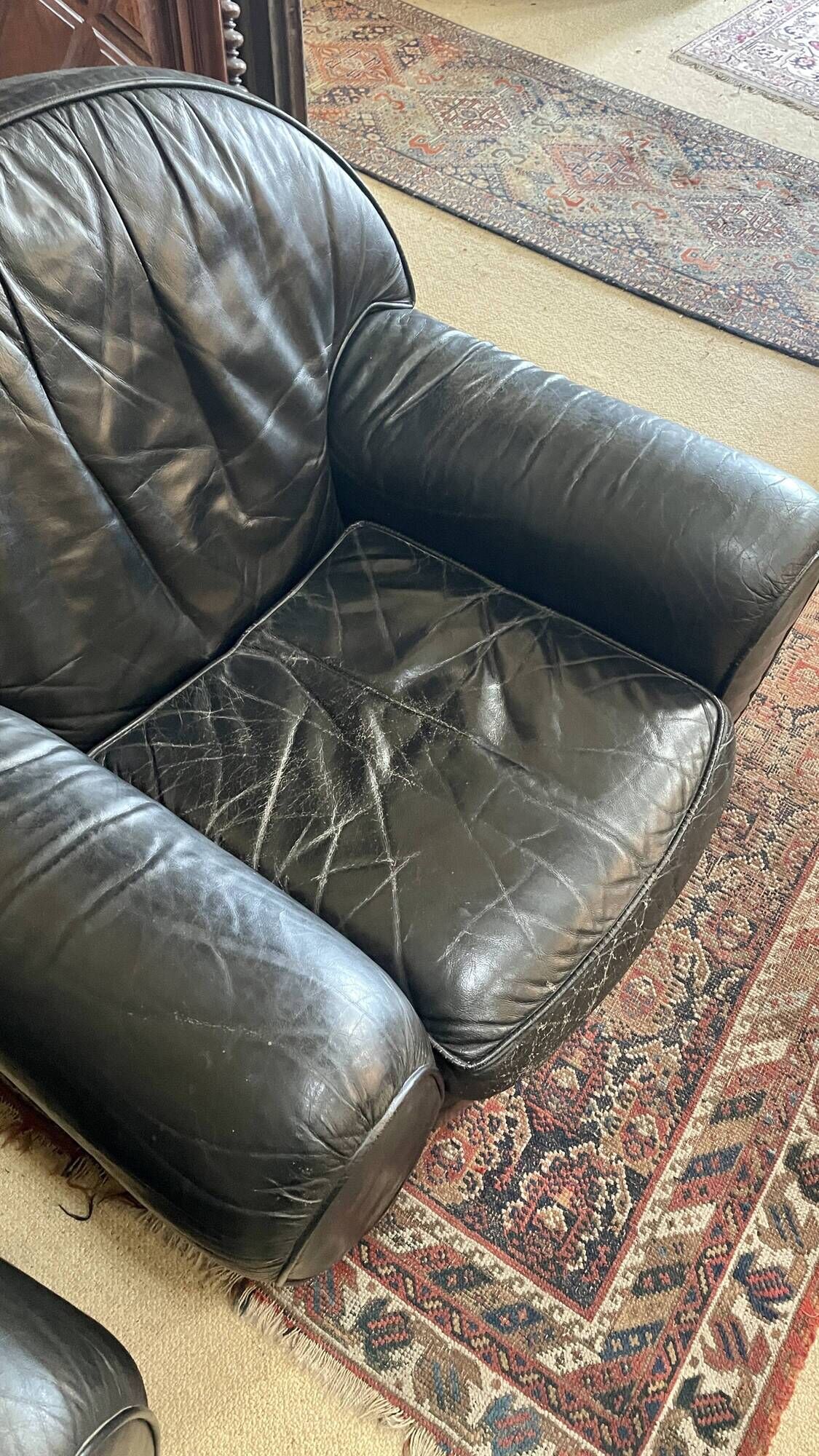 Pair of black leather club armchairs, twentieth century
