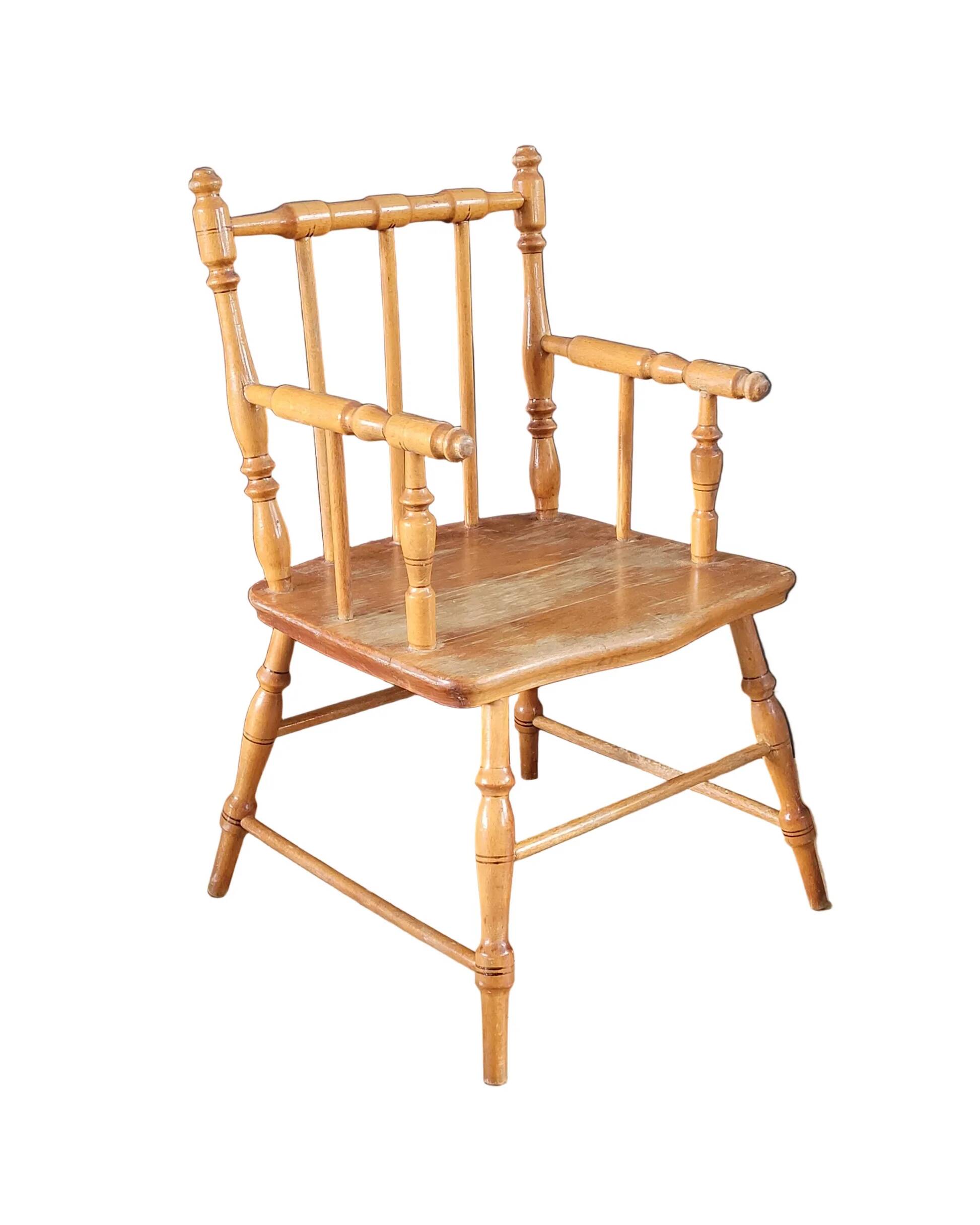 Antique wooden child's armchair from the early 20th century.