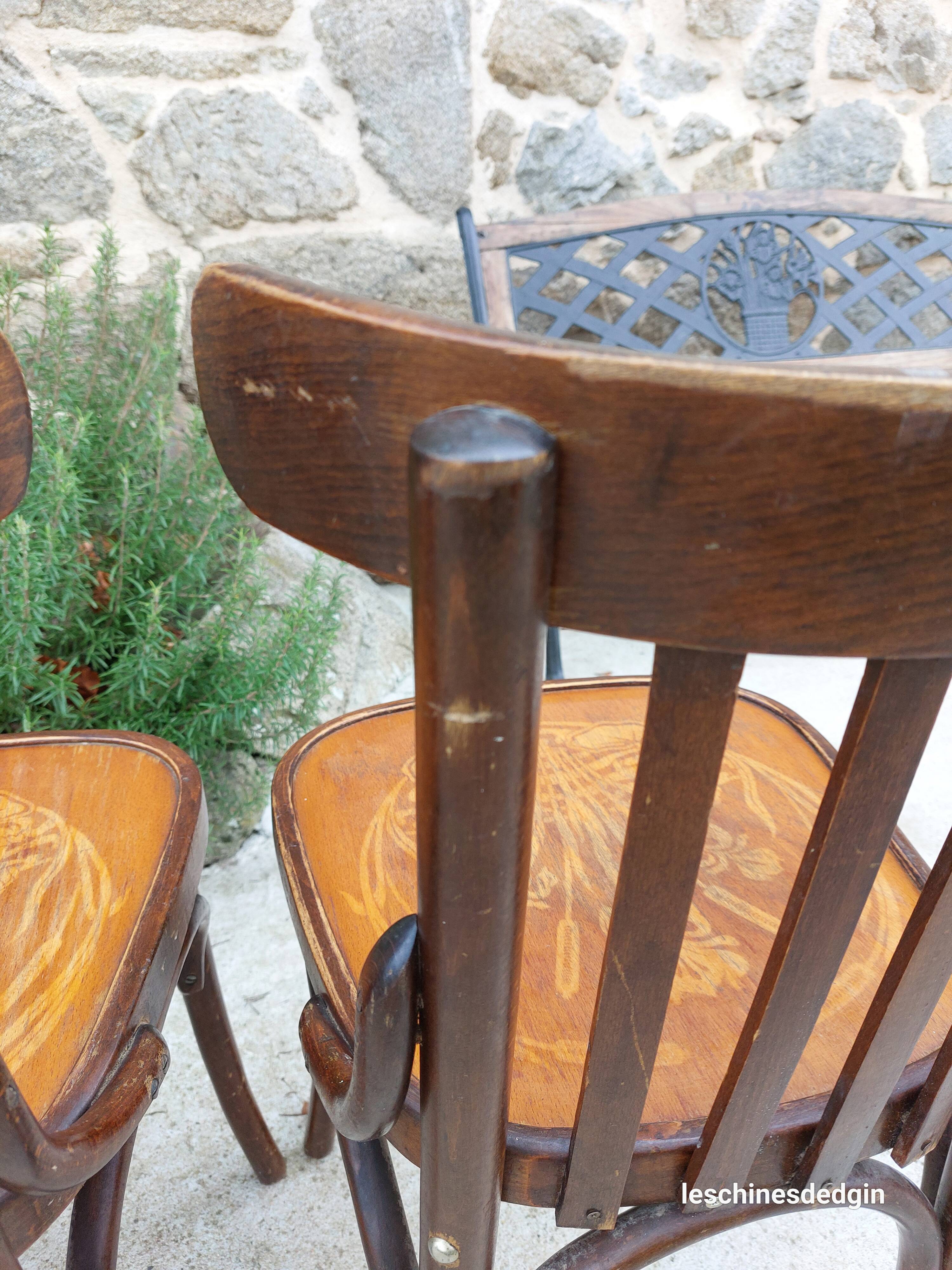 4 bentwood bistro chairs with a pattern on the seat