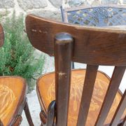 4 bentwood bistro chairs with a pattern on the seat