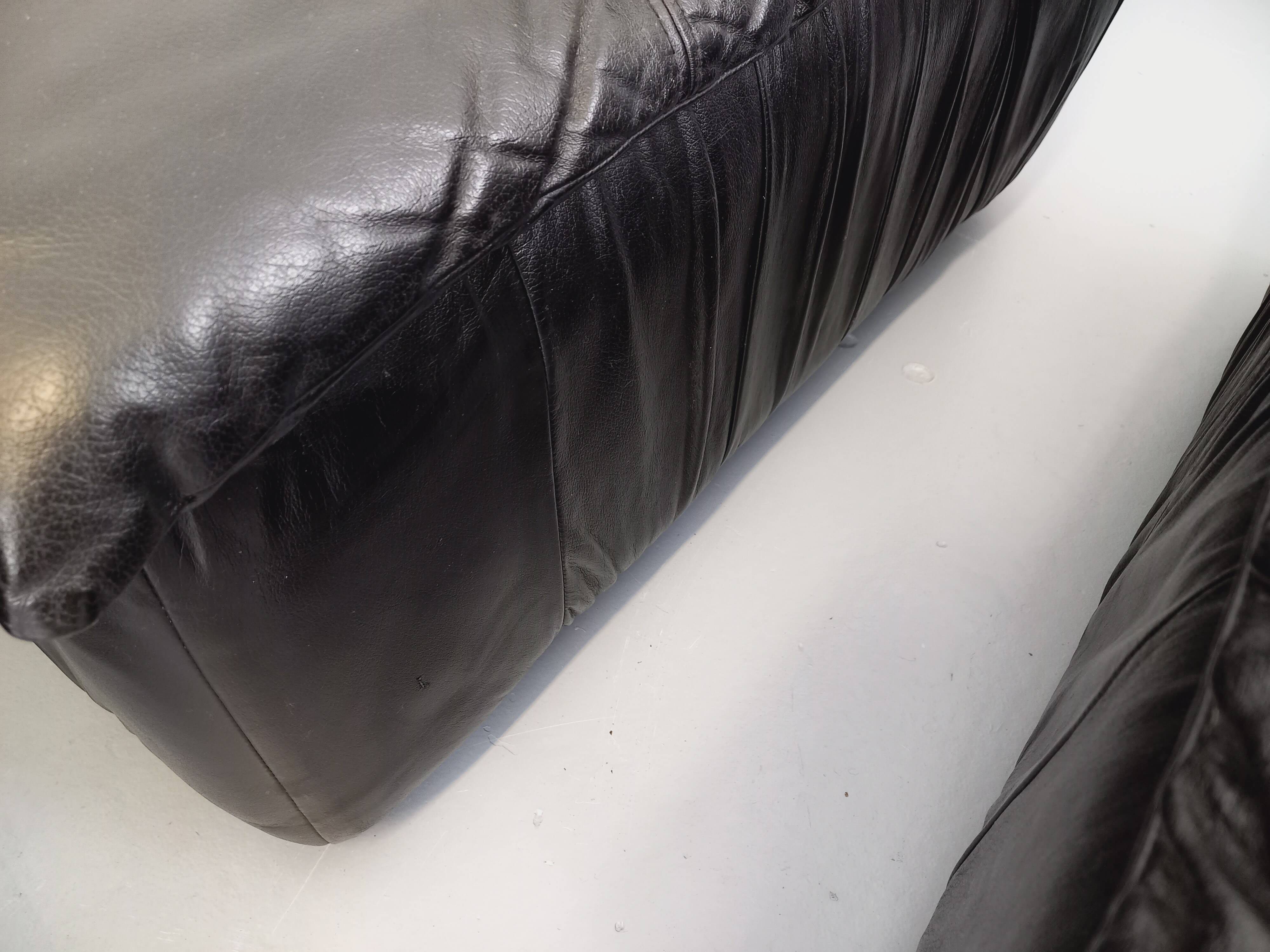 Vintage corner sofa composed of 3 modules in black leather with integrated bed.