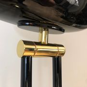 Black lacquered metal floor lamp with brass.