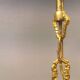 Older brass alloy chandelier with three light sources.