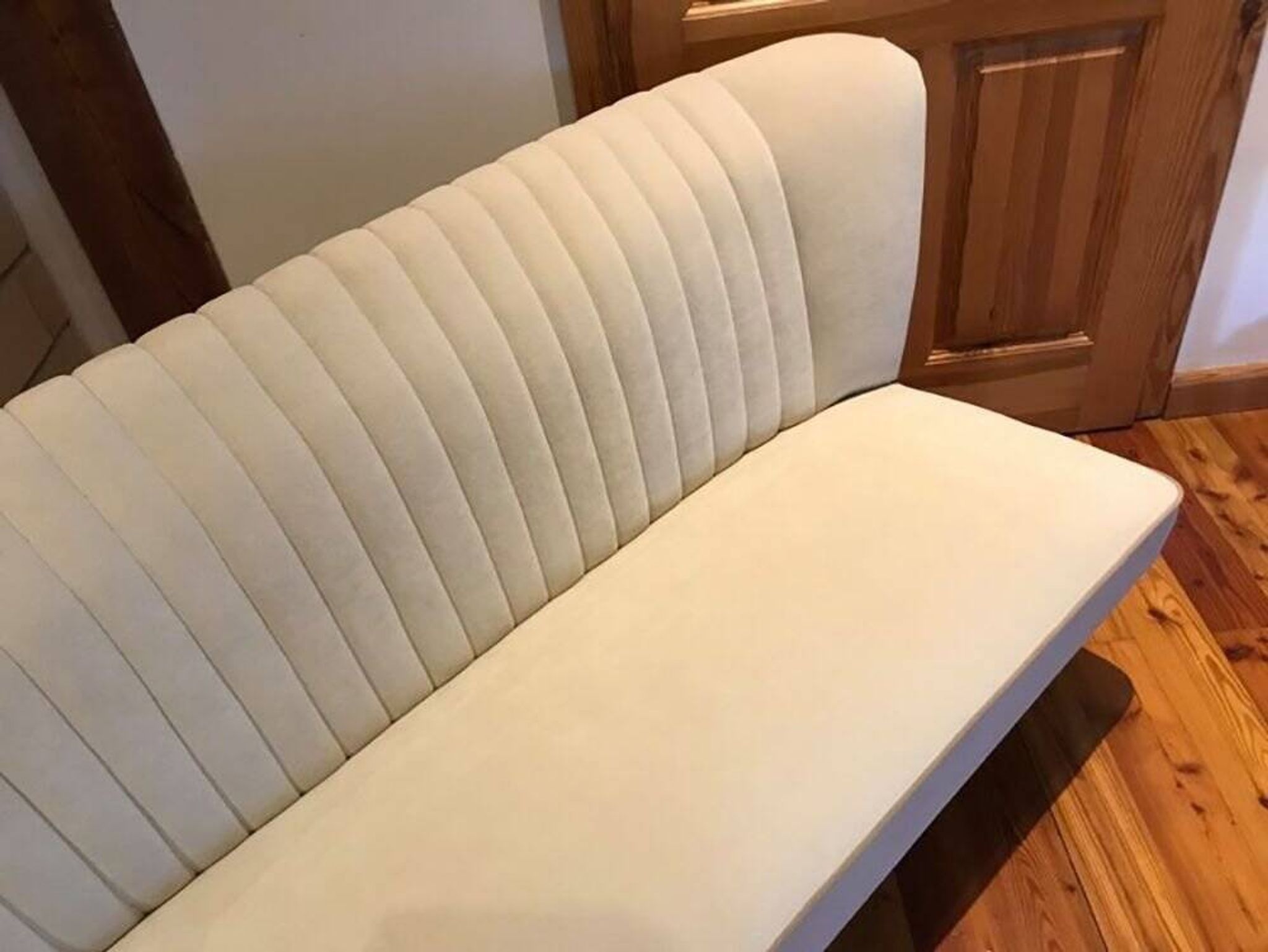 Mid-Century 1950s style two-seater canapé with cream fabric and solid beech.