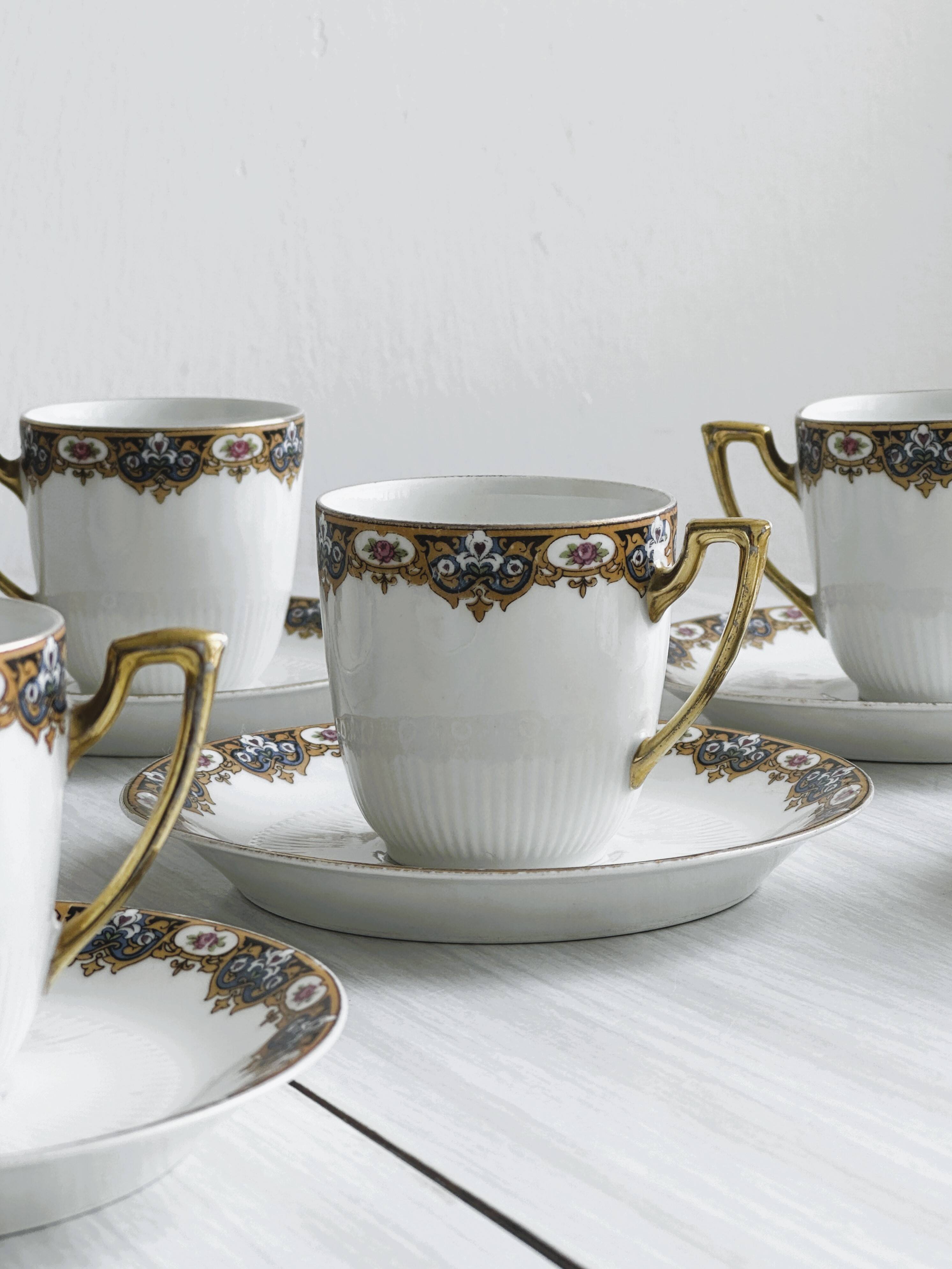 7 Limoges porcelain cups and saucers with gold decoration and floral motif.