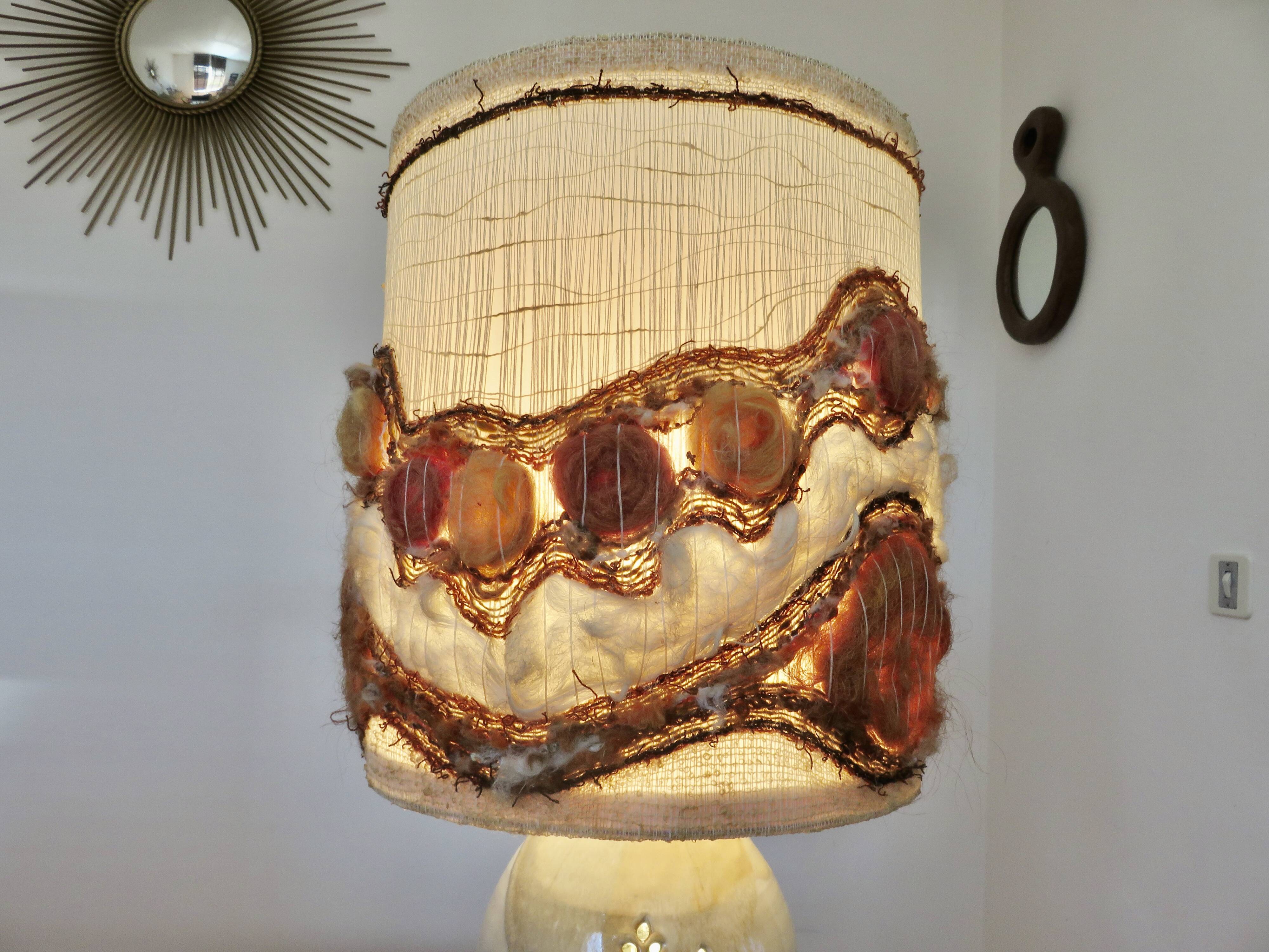 Ceramic lamp with double lighting and openwork design.