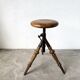 Tripod workshop stool in turned wood and cast iron — circa 1900