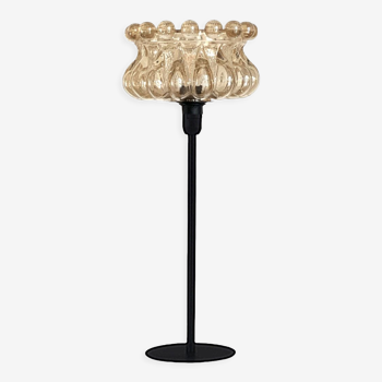 Table lamp with a golden glass lampshade, like a cup