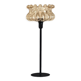 Table lamp with a golden glass lampshade, like a cup
