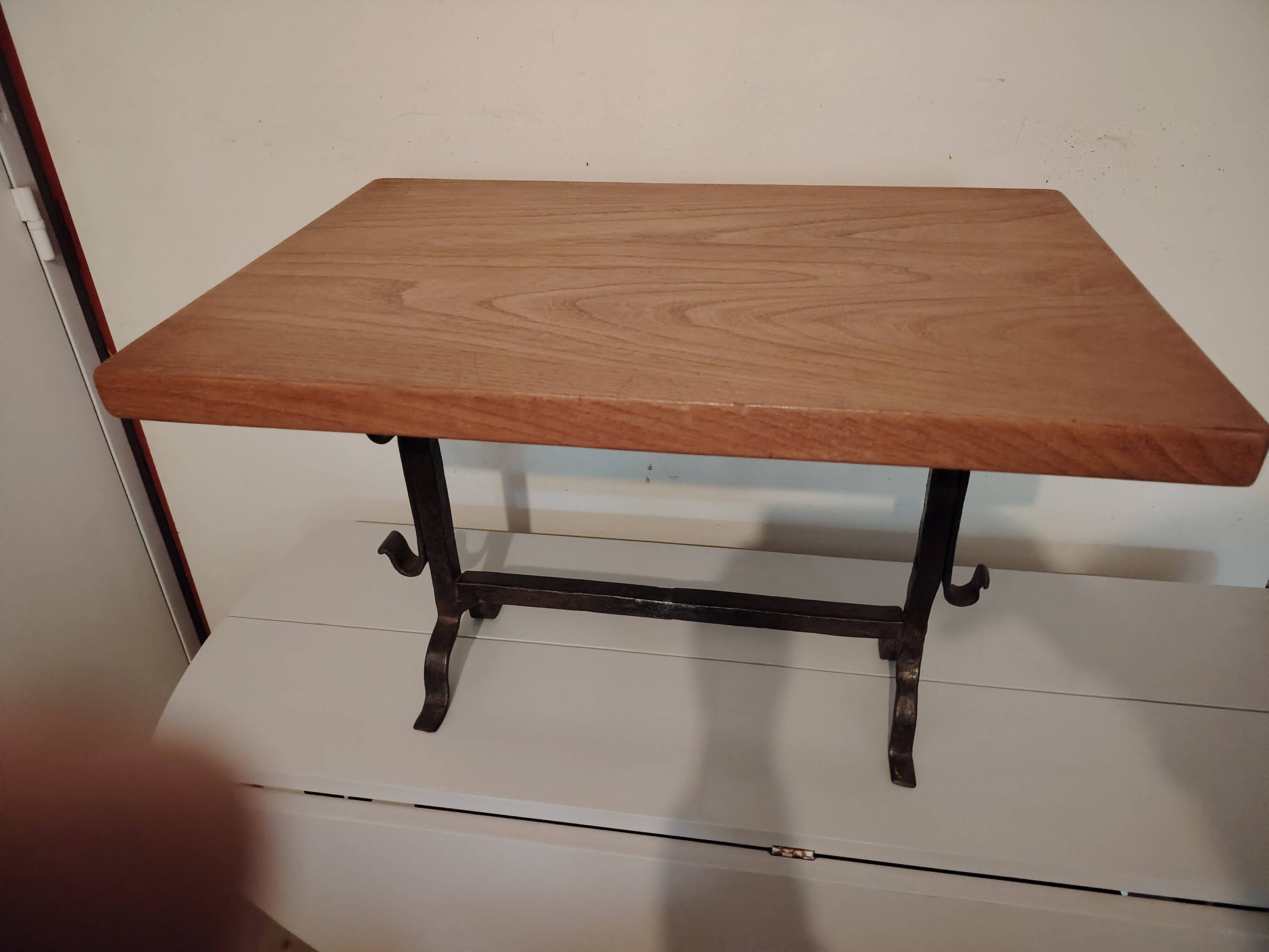 Solid wood and wrought iron coffee table