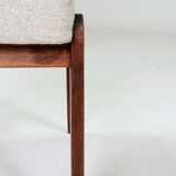 Pair of wooden stools with beige fabric.