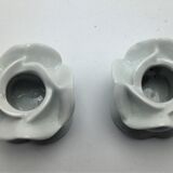 pair of white APILCO porcelain candlesticks in the shape of pink flowers