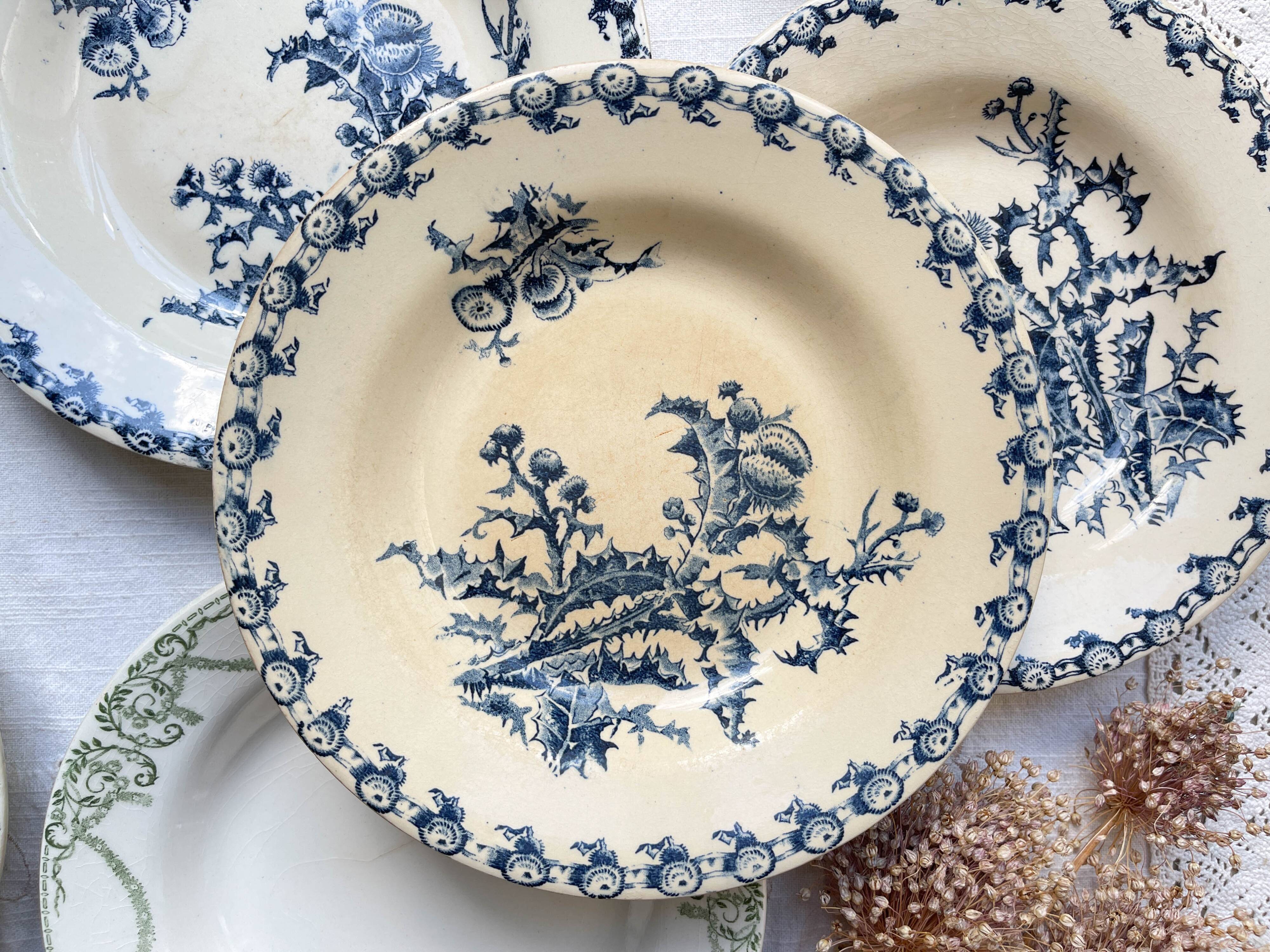 10 mismatched vintage soup plates in blue, green, and red ironstone