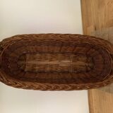 Vintage brown wicker baguette basket, elongated shape, with integrated handles.