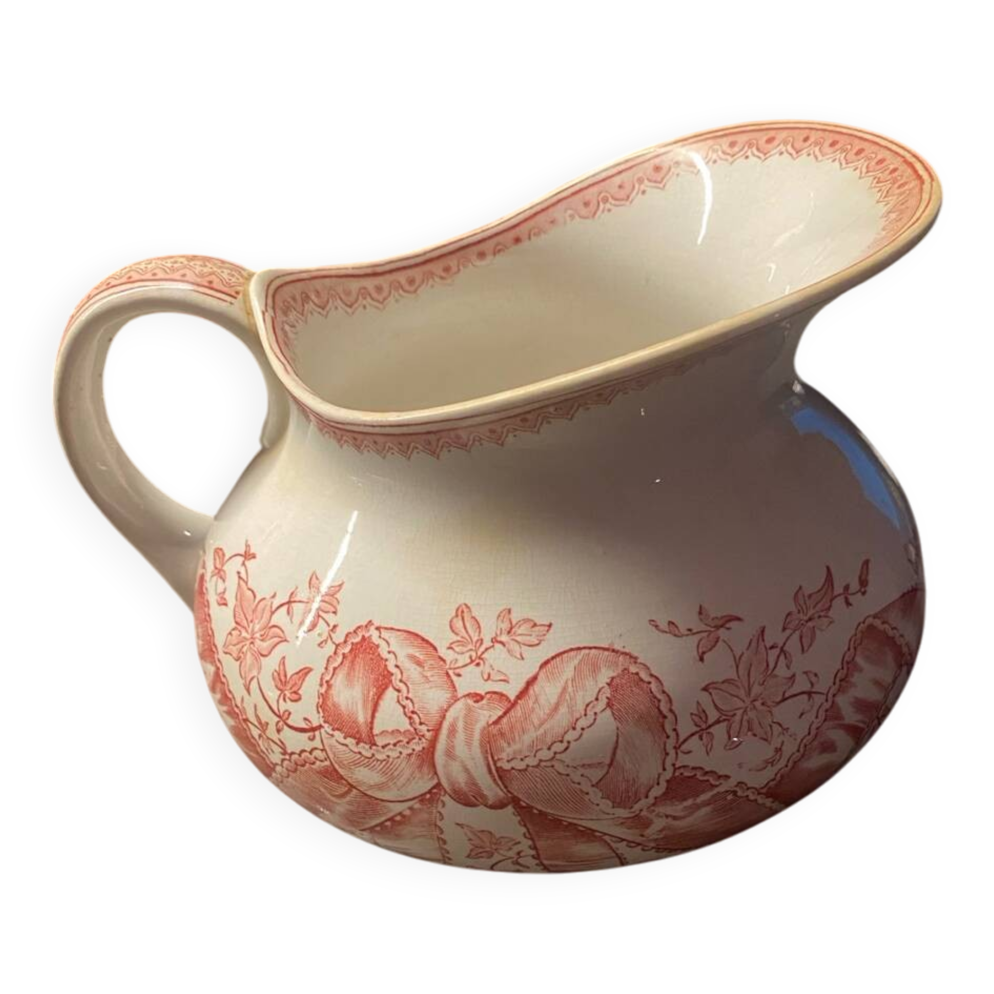 Old pitcher in red-decorated earthenware.