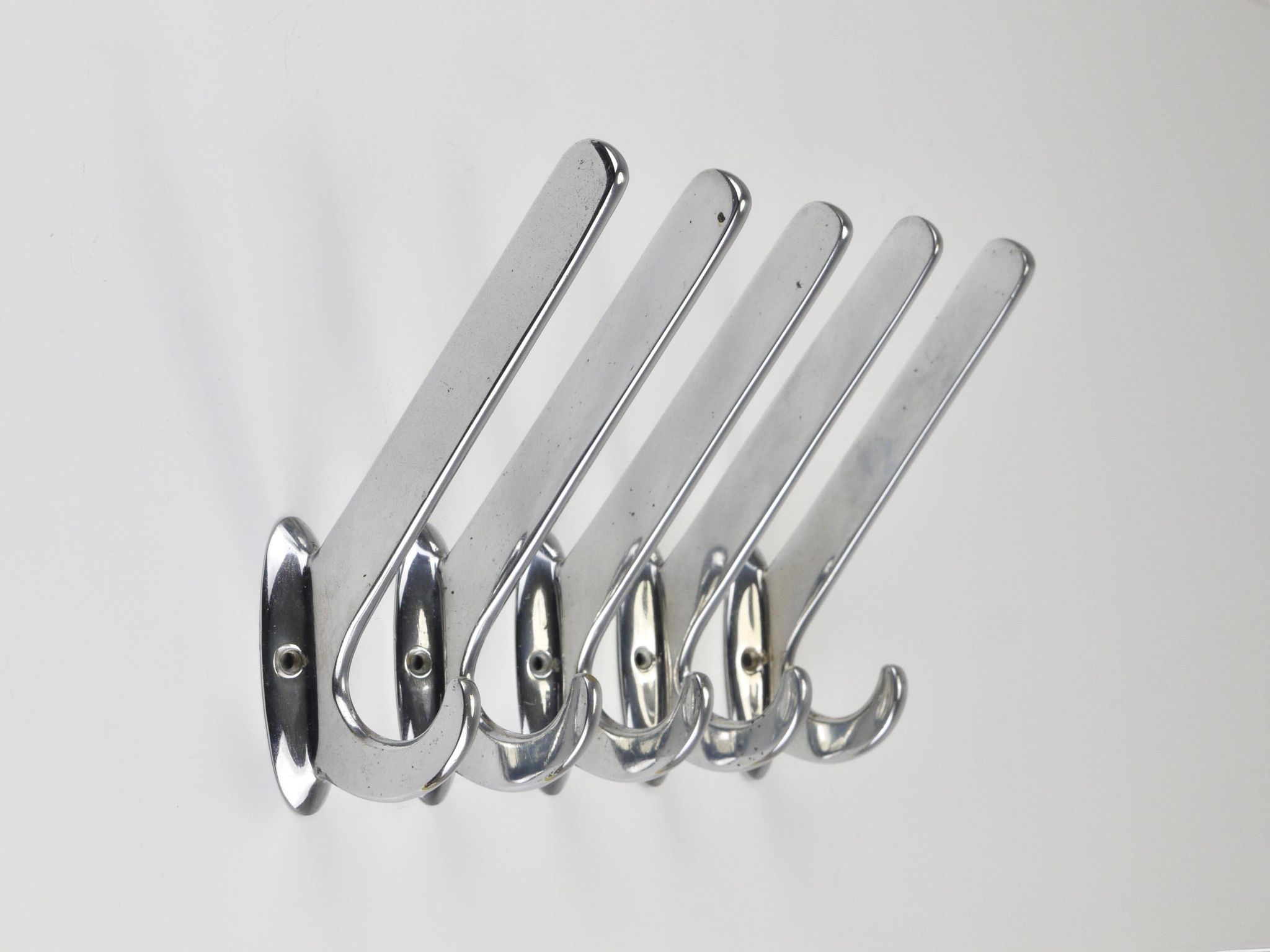Up to 5 large Art Deco Bauhaus wall hooks in nickel and brass, Vienna, 1930s.