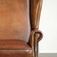 Sheepskin wingback armchair with patina finished with decorative nails