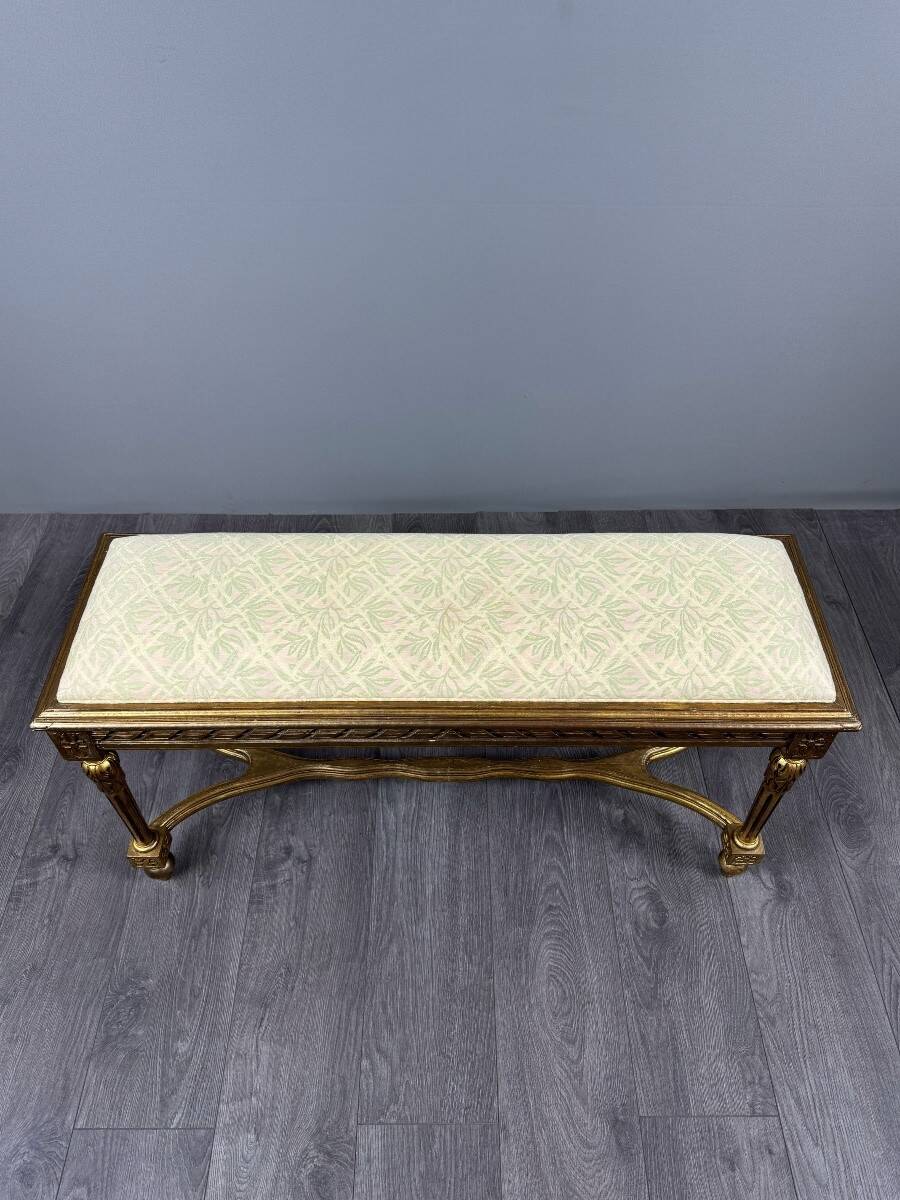 Antique gilded wooden bench in Louis XVI style, 19th century.