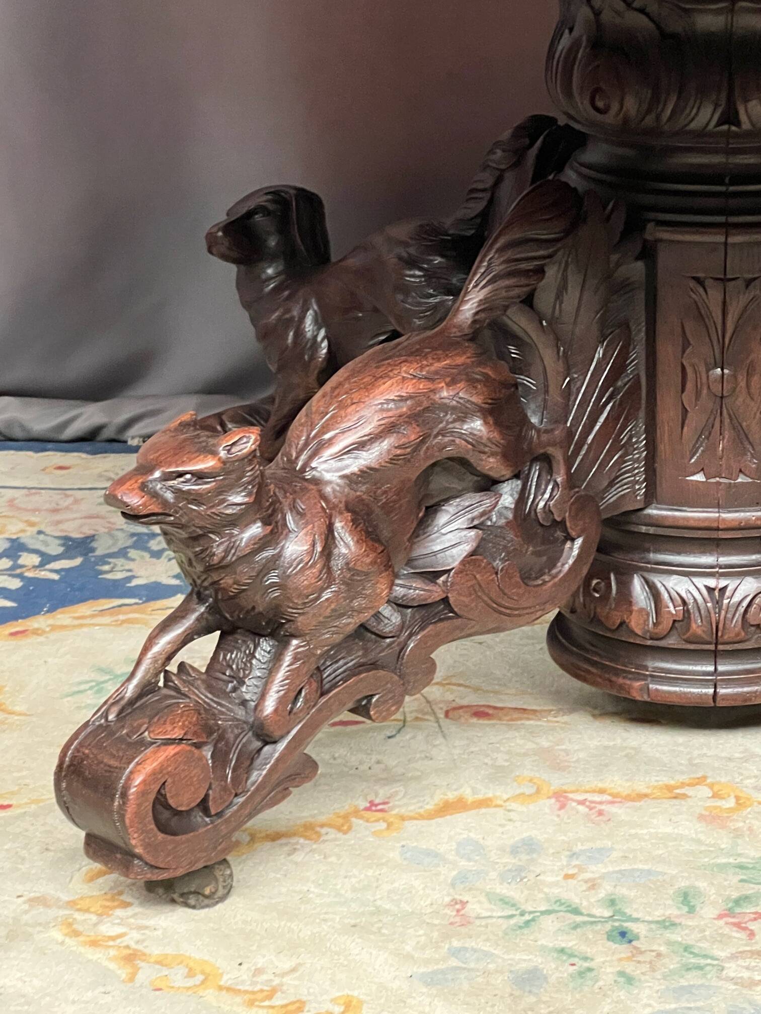 Hunting style dining table with figures of four different animals.