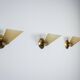 Set of three brass sconces with decorated yellow glass shades