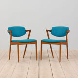 Pair of 42 Kai Kristiansen teak chairs in original blue bouclé upholstery, Denmark, 60s.