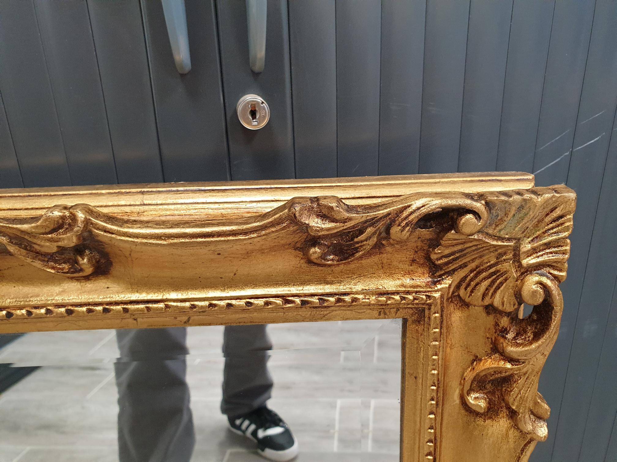 Beveled mirror and golden wood
