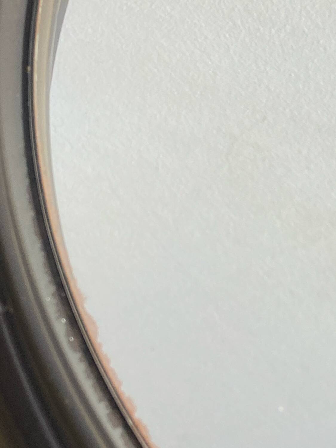 Circular mirror, smoked plastic, 1960s/70s.