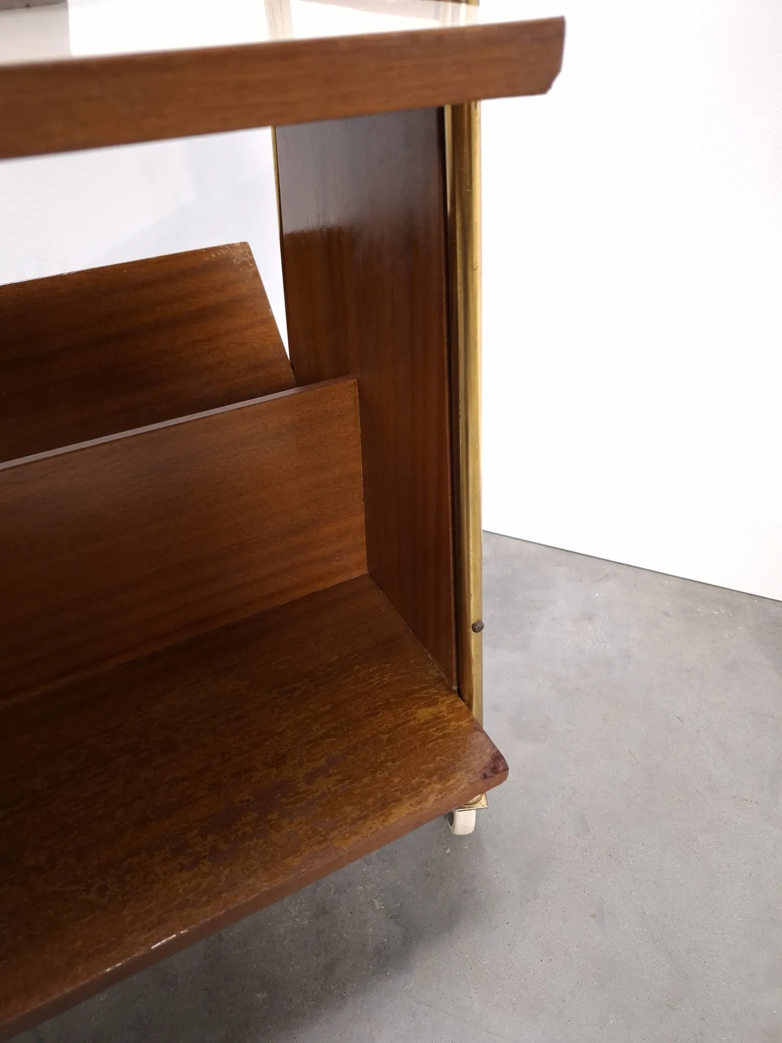 Vintage 1950s side table with a reading basket, formica top, teak wood.