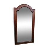 Old beveled solid wood mirror of a cabinet door.
